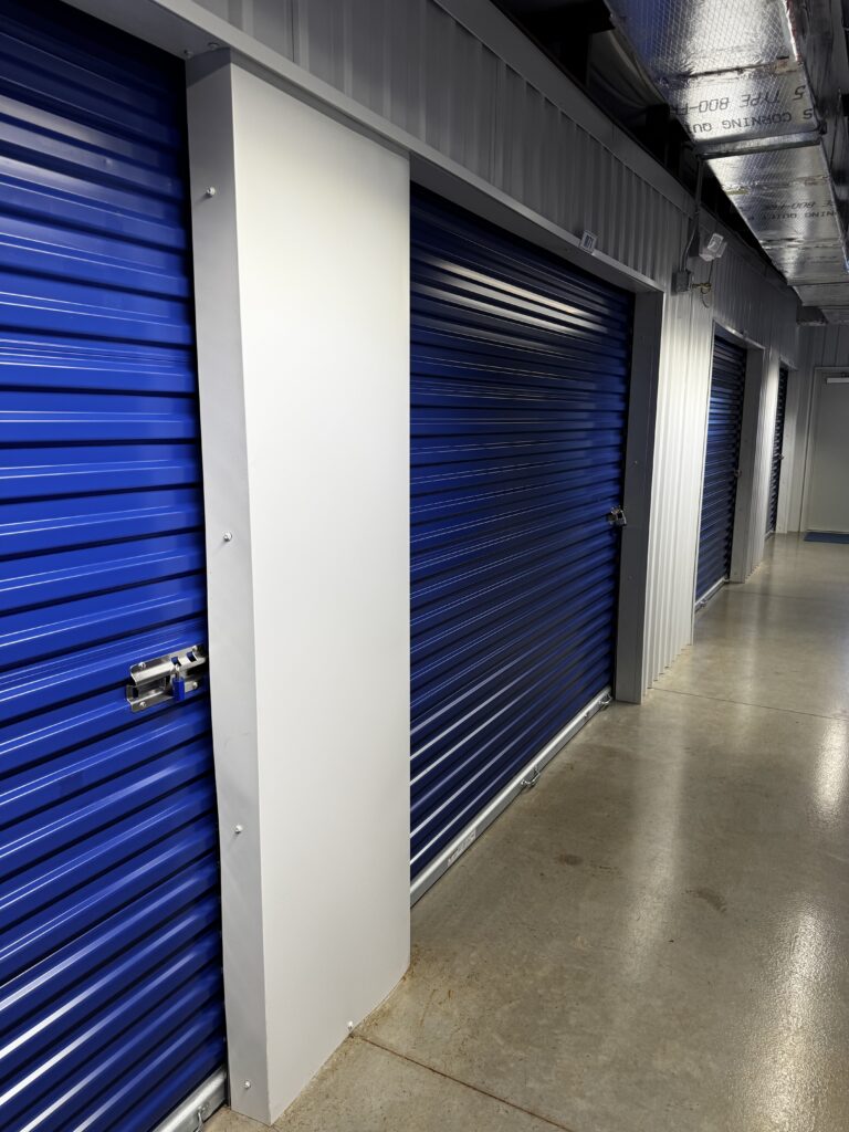 Indoor climate controlled storage hallway with blue unit doors at Florida Secure Storage of Ocala